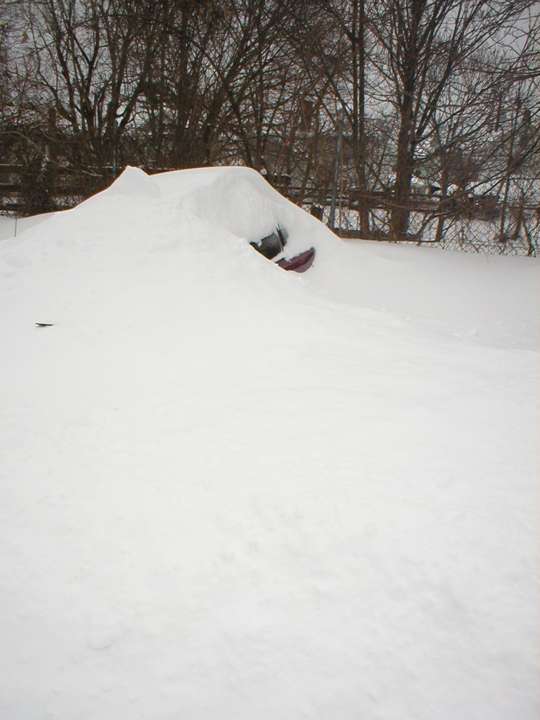 This picture shows what was visible of a car that was nearly buried by the heavy snowfall and drifted snow.