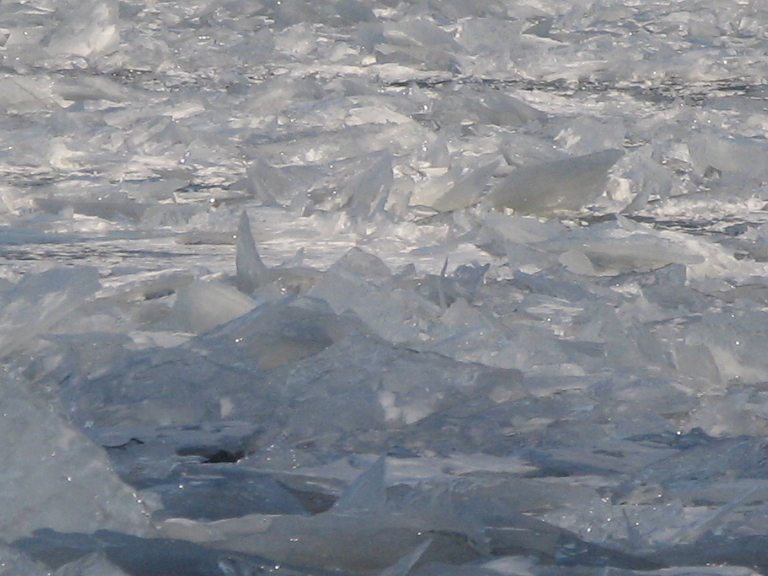 This picture shows the broken ice piled up near the shore.