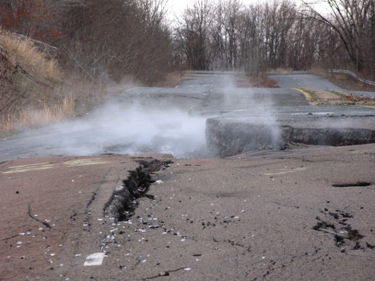 Smoke rising from Cracked road in Centralia from sustenance due to the underground mine fire.