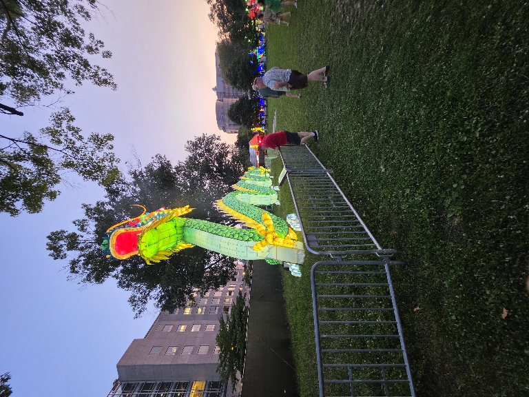 This picture shows the lit up long green dragon at the Chinese Lantern Festival. It's still dusk, but the illumination is very visible.