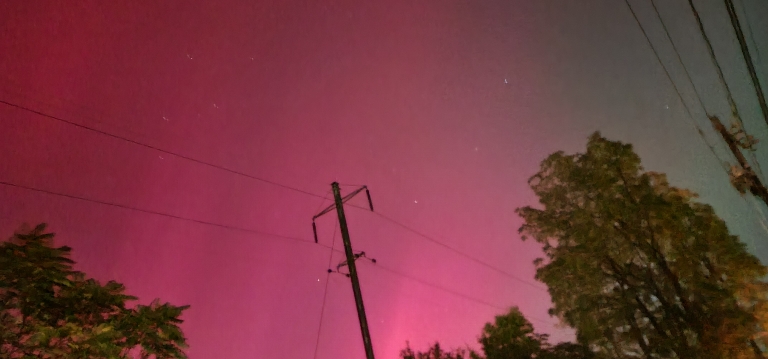 This a picture depicts the northern lights. The colors are green and red.