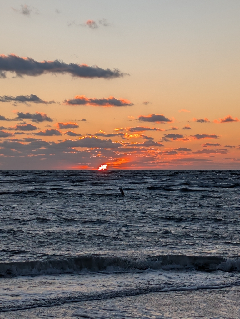 This picture shows a view of a sunset over the water of the Gulf of Mexico.
