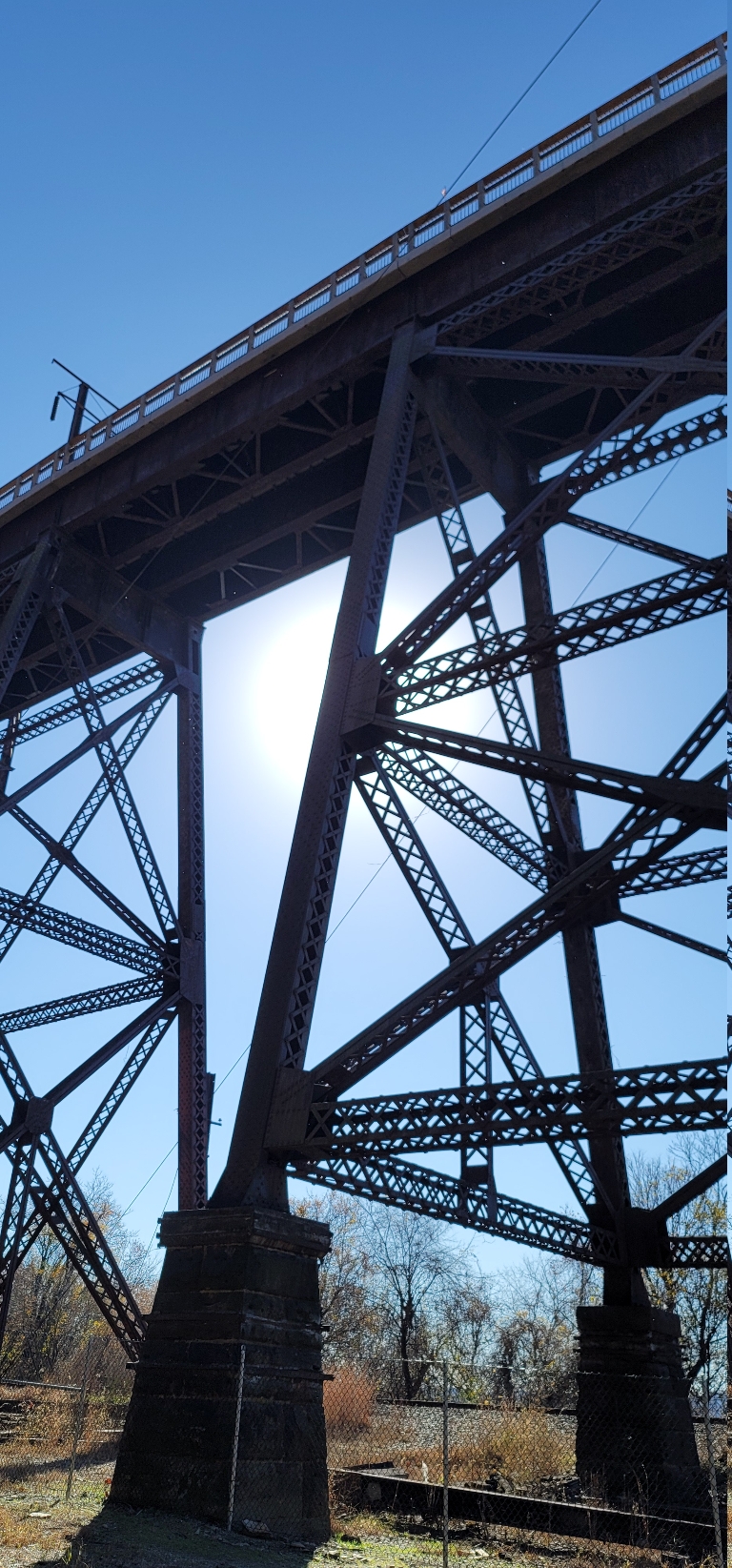This is the view of the trestle holding the Enola Low grade Rail trail from below the the sun just behind it.
