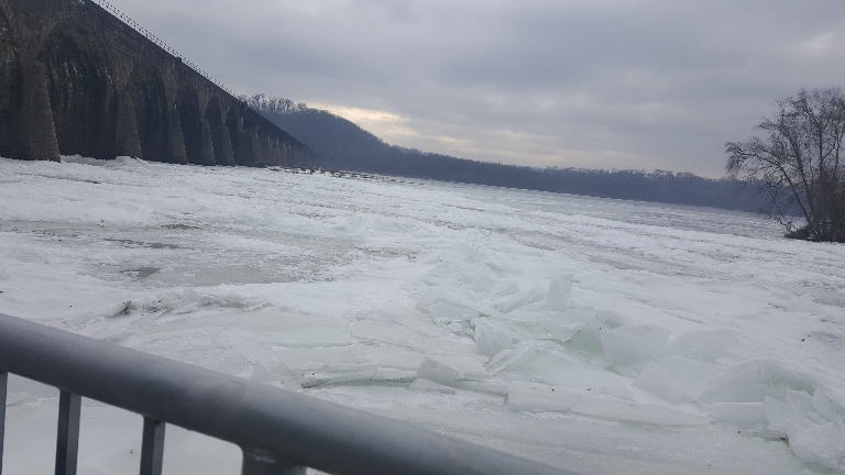 This is a picture showing lots of ice still on the river near the Shocks Mills Railroad bridge.