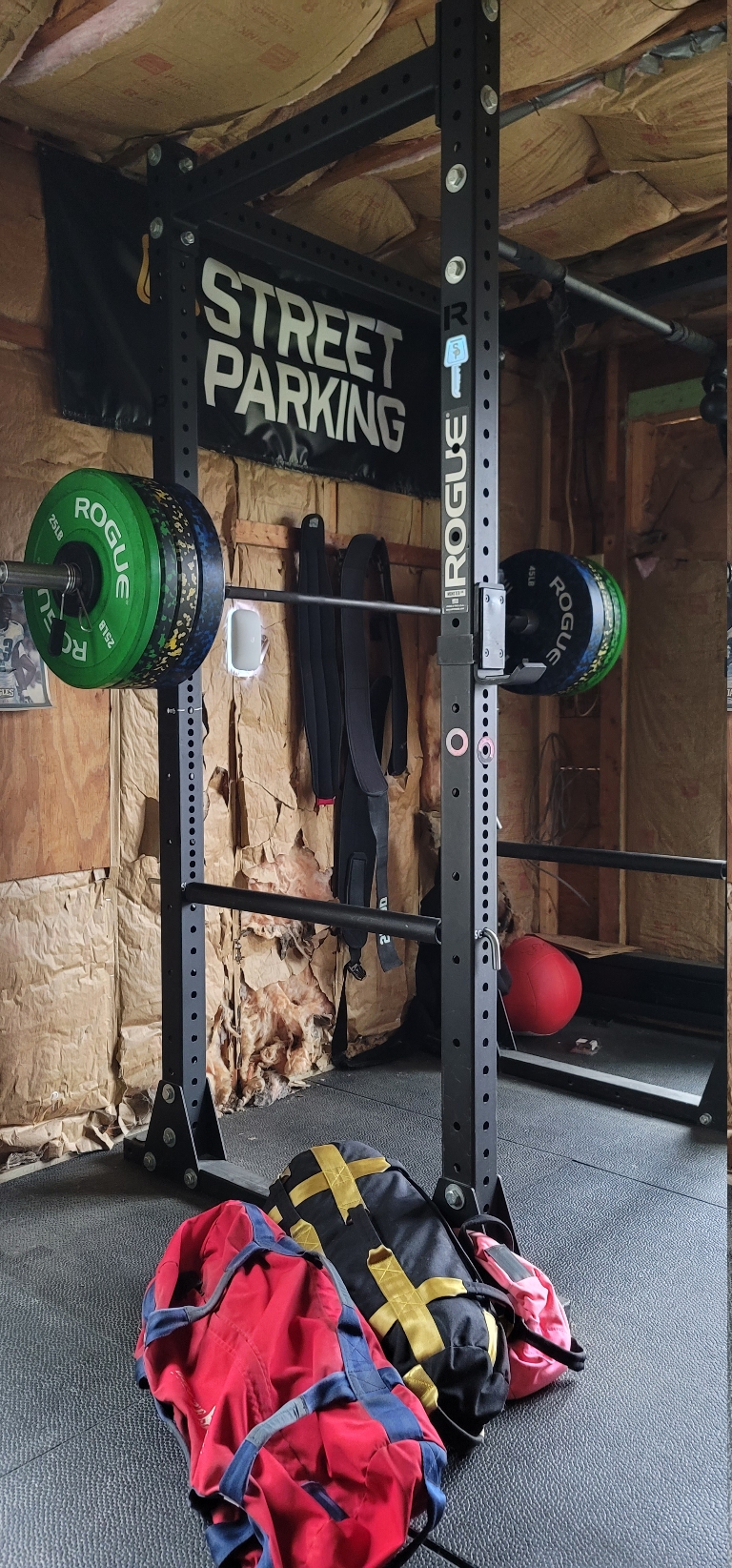 This picture shows a loaded barbell on a rack. The bar is loaded with 310 pounds worth of bumper plates.