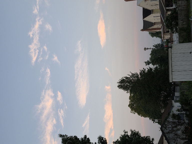 Here is a photo of some predawn underlit clouds in the sky. They are orangish and pinkish.