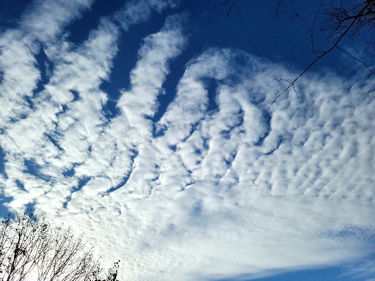 This depicts an area of very white clouds against a deep blue sky.
