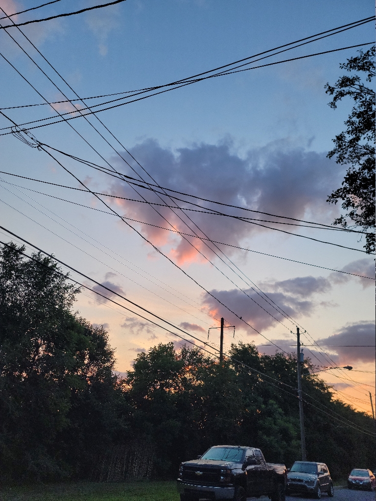 This is a picture of the clouds in in the sky glowing a bright pink on their edges color from the sunrise