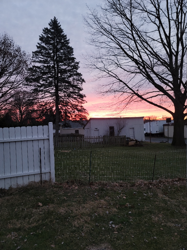 This is a picture of the sunrise. The clouds are orange and pink and are very vividly colored.