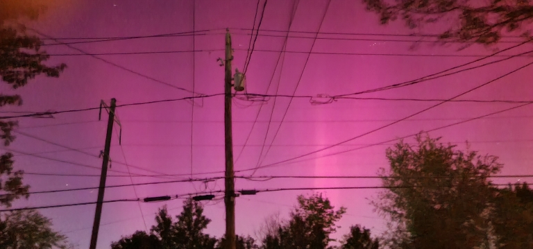 This shows bright pink Aurora borealis in the sky
