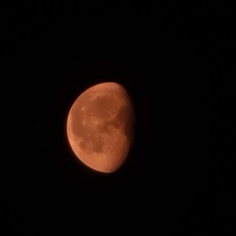 This picture the partial moon. It's very reddish orange in color due to the wildfire smoke.
