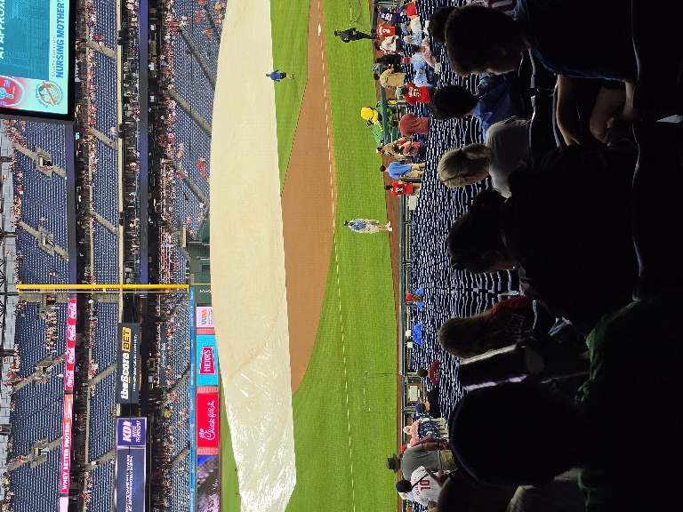 Here is a picture of the tarp being taken off the field.
