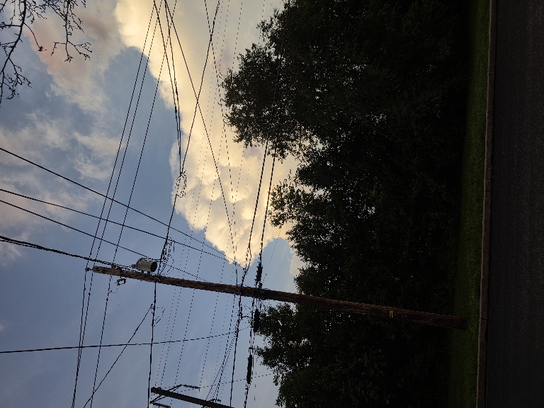 This picture shows the upper portions of a thunderstorm tower lit up bright white with clear skies around it as it was approaching.
