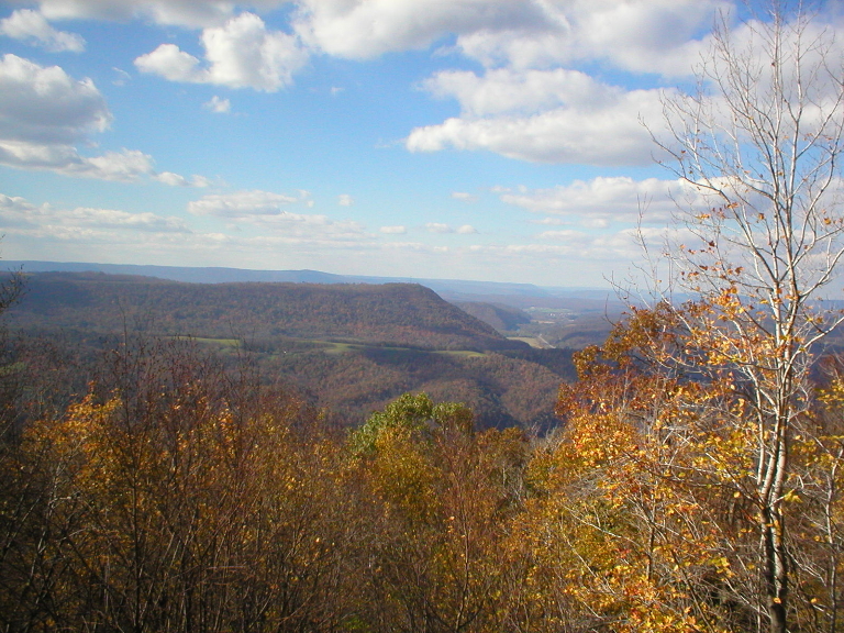 This is a photo showing one of the views of the mountains and valleys and fall colored foliage throughout the valleys and mountains.
