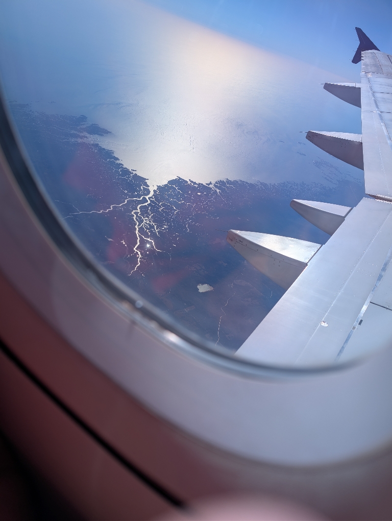 This picture shows the land and water from the window of a jet. I believe it was probably Florida and the Gulf of Mexico.